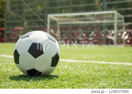 Soccer Ball on Field in Front of Goal Post Soccer Ball on Field in Front of Goal Post 129037090