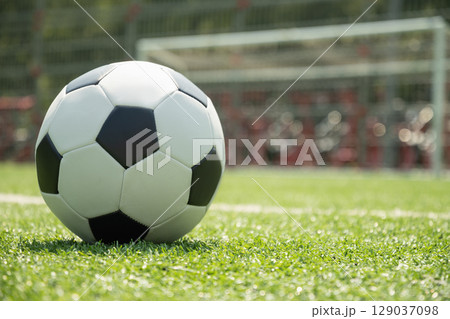 Soccer Ball on Field in Front of Goal Post 129037098
