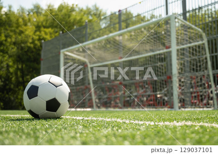 Soccer Ball on Field in Front of Goal Post Soccer Ball on Field in Front of Goal Post 129037101