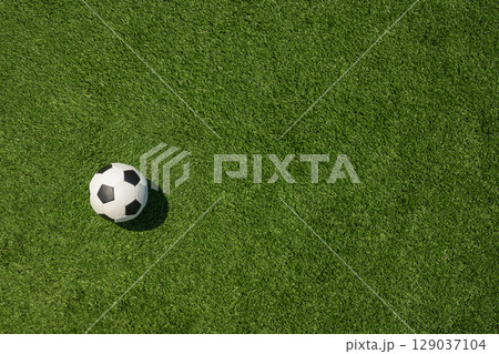 Soccer Ball on Green Grass Field with White Corner 129037104