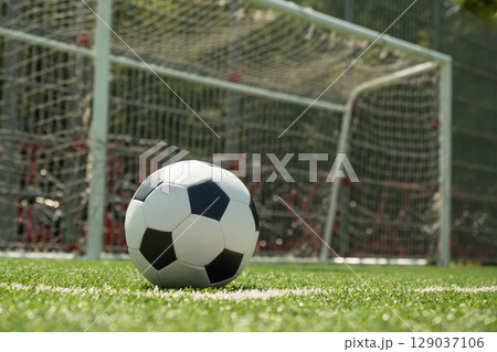 Soccer Ball on Field in Front of Goal Post Soccer Ball on Field in Front of Goal Post 129037106