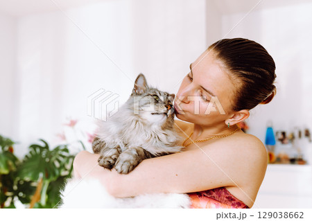 Portrait young woman with pet cat Portrait young woman with pet cat 129038662