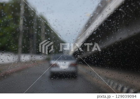 car on highway road with rainny season, blurred image 129039094