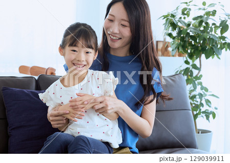 リビングで楽しく会話する母と娘 – 家庭的で リビングで楽しく会話する母と娘 – 家庭的で 129039911