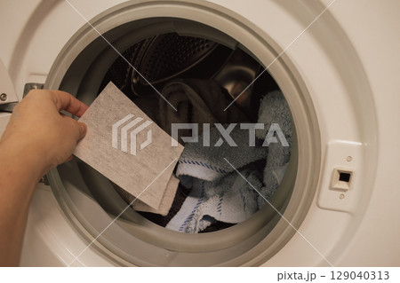 Color-catching sheet before being placed into the washing machine drum 129040313