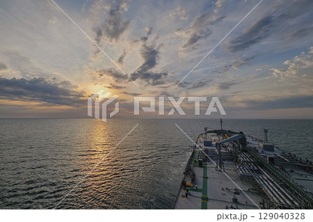Cargo ship at sunset, view from bridge, maritime trade 129040328