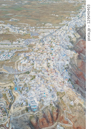 Aerial top view of Cycladic white houses in Oia, Santorini from a drone Aerial top view of Cycladic white houses in Oia, Santorini from a drone 129040403