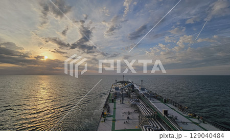 Cargo ship at sunset, view from bridge, maritime trade 129040484