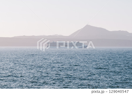 Cruise ship full of tourists sailing through the Mediterranean Sea to a new Greek island Cruise ship full of tourists sailing through the Mediterranean Sea to a new Greek island 129040547