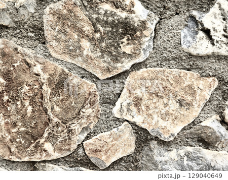 Stone wall texture background with natural masonry and cement joints 129040649