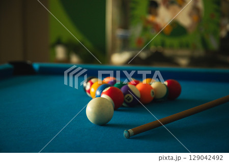Billiard balls arranged on a blue table ready for a game Billiard balls arranged on a blue table ready for a game 129042492