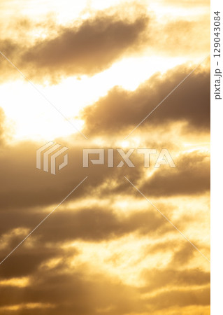 Golden Clouds at Sunset A beautiful display of natures artistry and vibrant colors Golden Clouds at Sunset A beautiful display of natures artistry and vibrant colors 129043084