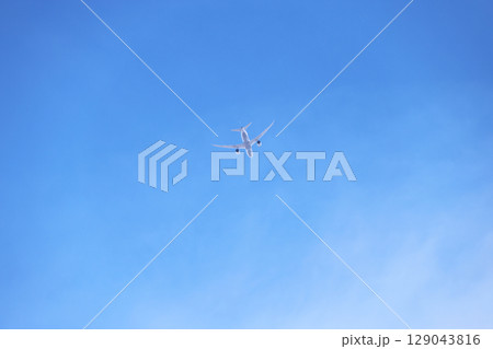 下から見上げた飛行機と青空 129043816