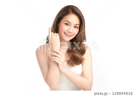 A beautiful young Asian woman with clean, fresh skin against a white background. Skincare, facial treatment, cosmetology, beauty, and spa. An elegant portrait of an Asian woman. A beautiful young Asian woman with clean, fresh skin against a white background. Skincare, facial treatment, cosmetology, beauty, and spa. An elegant portrait of an Asian woman. 129045018