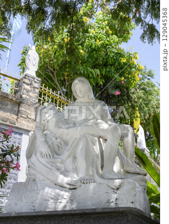A sculpture of the Virgin Mary and Christ based on Michelangelo's Pieta near the Catholic cathedral 129045368