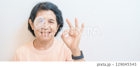 Elderly Woman with eye protective shield after eye surgery. Eye disease, Cataract,  Glaucoma, Age Related Macular Degeneration, Diabetic Retinopathy, Vitreous, Lasik, World Glaucoma day and health 129045543