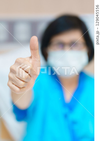 Elderly asian Patient Woman recovery after surgery. Happy Senior illness resting in hospital. Influenza, Fever, treatment, Insurance, Health care and medical, world day of Sick and Health day concept 129045556