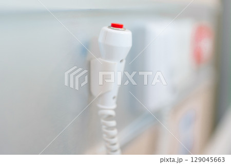 emergency button in hospital room, calling nurse in emergency case. Professional Medical system and Safety Alert emergency button in hospital room, calling nurse in emergency case. Professional Medical system and Safety Alert 129045663