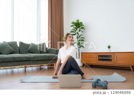 Young Asian woman stretching yoga workout on exercise mat Young Asian woman stretching yoga workout on exercise mat 129046899