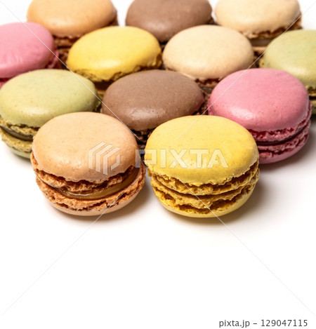 Small colorful tasty sweet original classic macaroons cakes isolated on white studio background 129047115