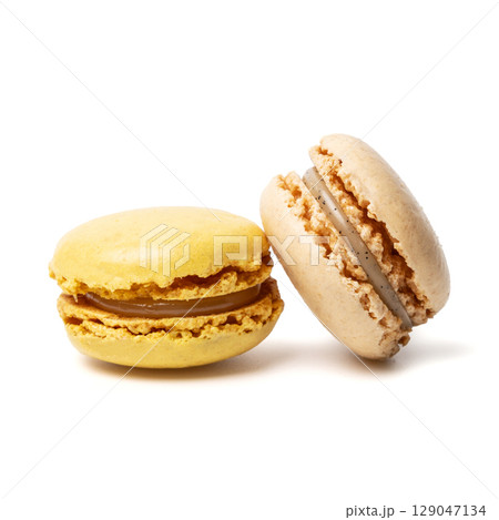 Small colorful tasty sweet original classic macaroons cakes isolated on white studio background Small colorful tasty sweet original classic macaroons cakes isolated on white studio background 129047134