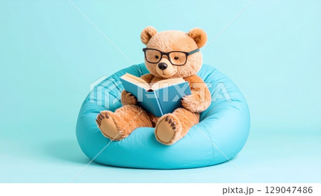3D rendering cute teddy bear sitting on soft blue sofa and reading book on blue background. 3D rendering cute teddy bear sitting on soft blue sofa and reading book on blue background. 129047486