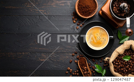 A hot coffee or chocolate drink, perhaps a cappuccino or espresso, served in a mug or cup with the inviting aroma of cinnamon and other spices on a breakfast table A hot coffee or chocolate drink, perhaps a cappuccino or espresso, served in a mug or cup with the inviting aroma of cinnamon and other spices on a breakfast table 129047487