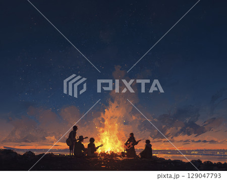 Group of friends sitting around campfire on beach at night, playing guitars and enjoying starry sky with warm glow from fire illuminating their silhouettes 129047793