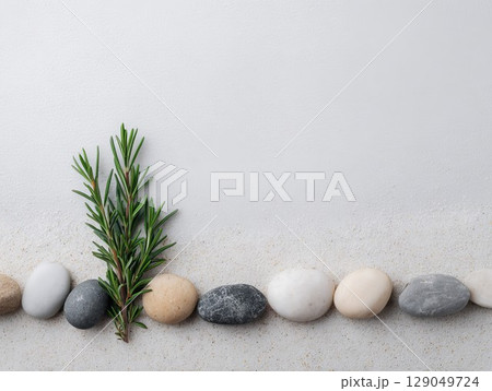 Sage and lavender stems with white pebbles on soft sand. Herbal blend creates relaxing wellness backdrop. Sage and lavender stems with white pebbles on soft sand. Herbal blend creates relaxing wellness backdrop. 129049724