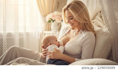 Blonde woman breastfeeding her baby 129050089