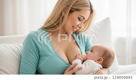 Blonde woman breastfeeding her baby 129050093
