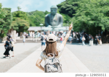 Woman tourist Visiting in Kamakura, Kanagawa prefecture , Japan. happy Traveler sightseeing the Great Buddha statue. Landmark and popular for tourists attraction near Tokyo. Travel and Vacation 129050311