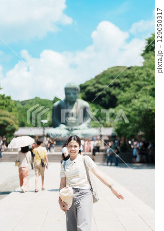 Woman tourist Visiting in Kamakura, Kanagawa prefecture , Japan. happy Traveler sightseeing the Great Buddha statue. Landmark and popular for tourists attraction near Tokyo. Travel and Vacation 129050317
