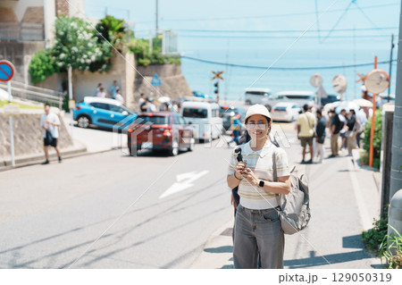 Woman tourist Visiting in Kamakura, Kanagawa, Japan. happy Traveler sightseeing Kamakurakokomae train station. Landmark and popular for tourists attraction near Tokyo. Travel and Vacation concept 129050319