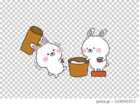 A cute and relaxed rabbit pounding mochi 129050353