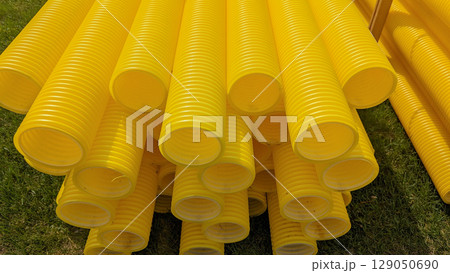 Modular plastic pipes for utility networks stacked outdoors, utility focus highlights infrastructure flow, utility system visuals suitable for city projects, installation guides 129050690