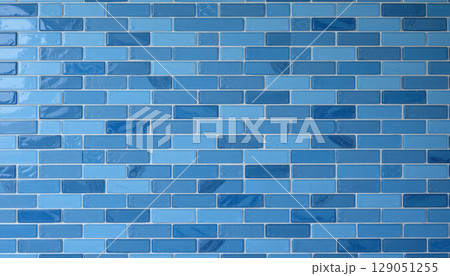 Blue tile wall with glossy finish and varied shades creating calm and modern atmosphere in interior design 129051255