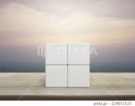Four white block cubes on wooden table Four white block cubes on wooden table 129051525