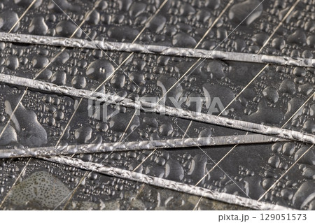 a wet blade for a knife close up, a sharp blade for a knife for repair work covered with water droplets 129051573