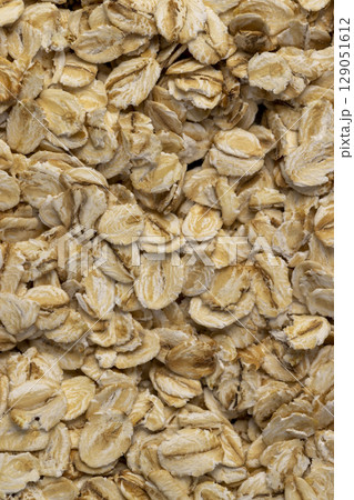 a large number of flakes from pressed oat grains, ingredients for cooking porridge a large number of flakes from pressed oat grains, ingredients for cooking porridge 129051612