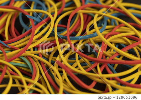 rubber bands for money, close up, rubber bands of different colors for packaging and organizing paper money rubber bands for money, close up, rubber bands of different colors for packaging and organizing paper money 129051696