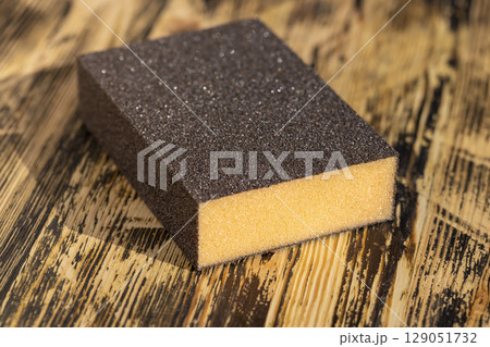 wooden board made of pine planks for polishing with sandpaper on the construction site wooden board made of pine planks for polishing with sandpaper on the construction site 129051732