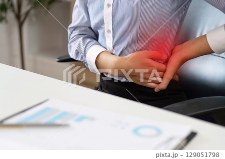 Office Syndrome: Female Worker Suffering from Side Pain at Desk 129051798