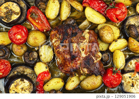 Appetizing baked pork with vegetables. 129051906