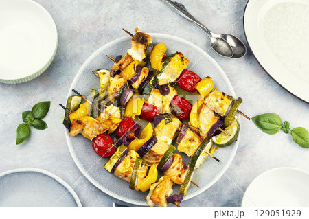 Grilled fish on skewers, food photography. 129051929