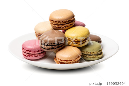 Small tasty sweet original classic macaroons cakes on plate isolated on white studio background Small tasty sweet original classic macaroons cakes on plate isolated on white studio background 129052494