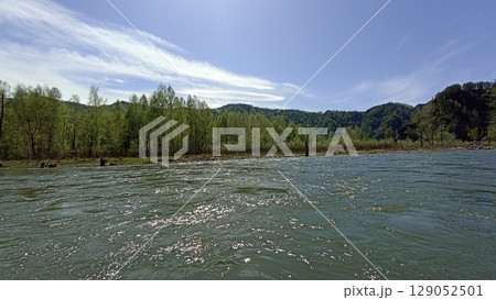 Idyllic River Landscape with Lush Green Forest and Rocky Cliff in Summer Season Day Light 129052501