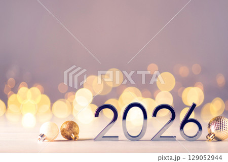 Metal numbers 2026 on table with bokeh lights. 129052944
