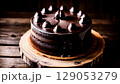 Decadent Dark Chocolate Cake with Glossy Ganache and Chocolate Decorations 129053279