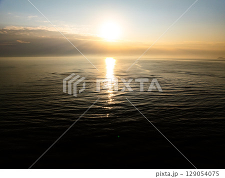 Aerial view sunset sky Beautiful light sunset or sunrise over sea Colorful scenery sunset sky waves texture background 129054075